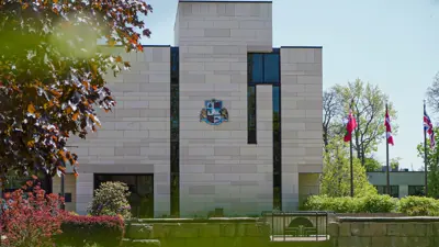 Exterior of the City Hall Building on a summer day.