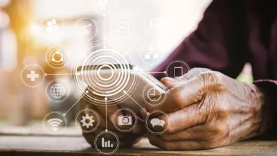 A close up of a person's hands holding a cell phone with graphics showing connectivity to information.